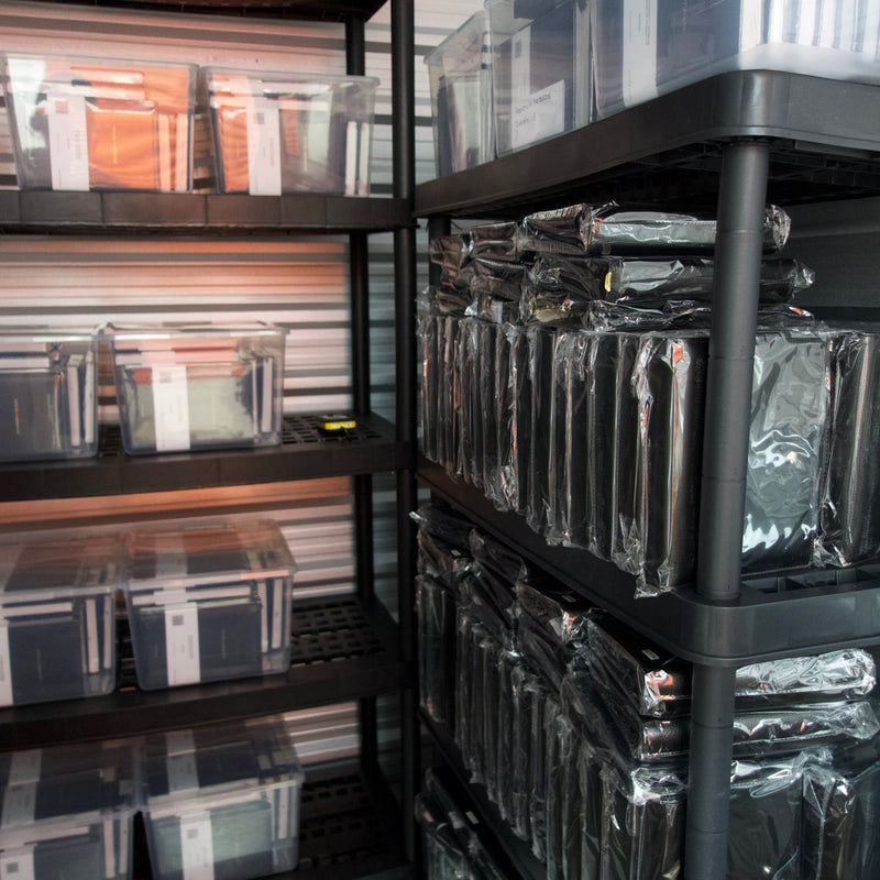 The Planner Shop storage unit with shelves filled with labeled boxes and containers.